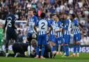 Albion players talk things over during the 2-1 defeat by Chelsea