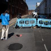 A man looks at the sinkhole in Robert Street