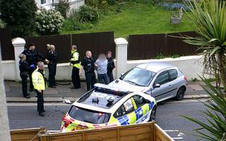 A man was arrested for dangerous driving following a crash with a police car in Brighton on Sunday afternoon
