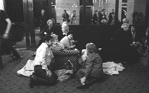 Conservative Party members sit around the foyer of The Metropole Hotel after they were evacuated from The Grand Hotel.