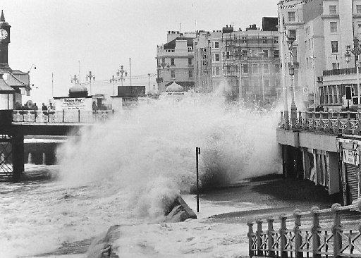 Heavy seas crash onto Brighton seafront by The Palace Pier during storms. November 1984.