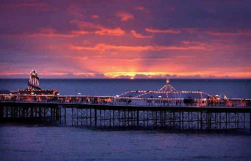 The sun sets over Brighton's Palace Pier on New Year's Day 2004.