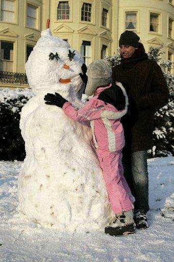 Children pictured playing in the snow in Brunswick Square, Hove. Pictured is Stuart Boseley, 37, and India Nicholson- Crisp, 9.