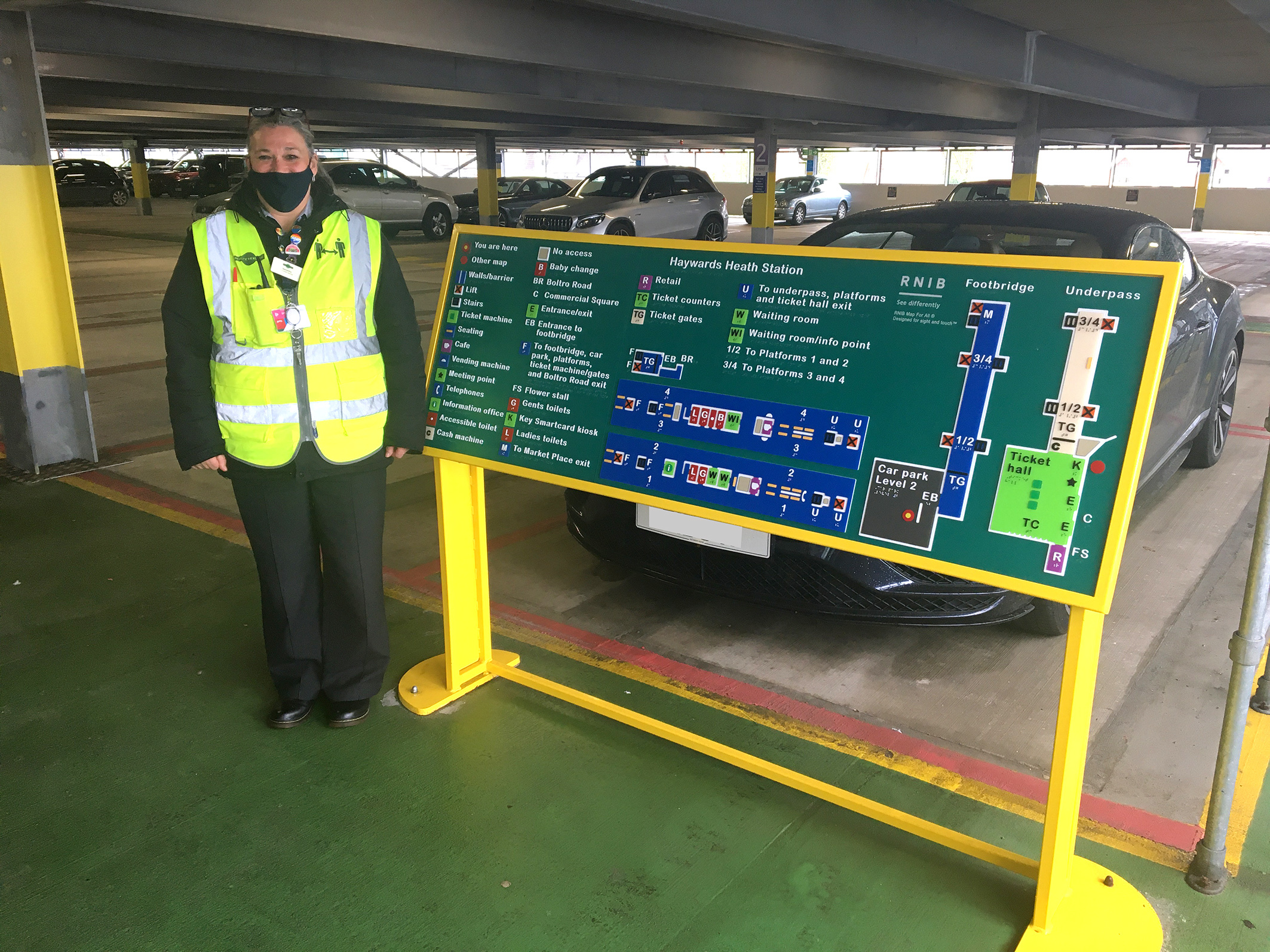 Haywards Heath - staff member Sam Huggett next to tactile map on level 2 of car park