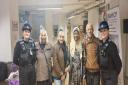 PCSOs Lauren Lewis, far left, and Tilly Earley, far right, with community members at a community centre