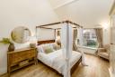 The master bedroom can fit a four-poster bed