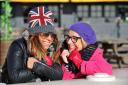 From left: Hedia Zitoune and Dee Ivison wrap up warm on Brighton beach as cold weather is set to hit the UK.  Picture: Allan Hutchings