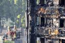 Firefighters inspecting the burnt-out shell of Grenfell Tower as the grisly task of removing the bodies continues.  Picture: Rick Findler/PA Wire