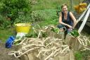 Emily O’Brien with bags of produce harvested as part of the community Veg Share project at Stanmer Organics in Brighton