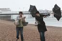 Sally Tarling and Nikki Yorke brave the weather for a walk along Brighton beach