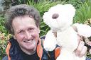 Simon Spinks with his teddy, which he took with him up the mountain