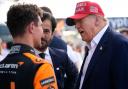 Former US president Donald Trump, right, talks Lando Norris after the Miami Grand Prix (Rebecca Blackwell/AP)