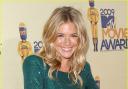 Sienna Miller looks party-perfect in a jewel-coloured dress