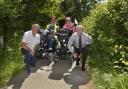 Members of Bay and Eastbourne Rollers, a group of mobility scooters and wheelchair users, with Councillor Kelvin Williams, left, and Shaun Peters, Wealden District Council’s crematorium and greenspaces manager
