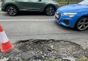 Motorist narrowly swerves 'artillery crater' sized pothole while driving