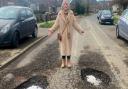 Councillor Alison Cornell shows the potholes in Crawley