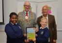 Mayor Brian Fitch and judge Keith Eade hand over the award to pupils from Moulsecoomb Primary School