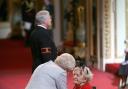 Marguerite Patten being made a CBE by Queen Elizabeth II at Buckingham Palace in 2010. Picture: Lewis Whyld/PA Wire