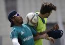England's Chris Jordan, left, and Reece Topley vie for a football as they warm up