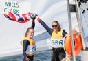 Saskia Clark and Hannah Mills celebrate on the water after winning gold