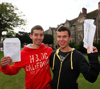 Twins Myles Holbrook (left) with an A* in economics, A in government & politics and A in core mathematics and Luke Holbrook with a statement of results for his A grade in history celebrate at Brighton College.