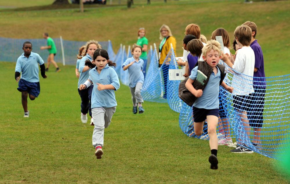 Children from Cottismore School run for the finishing line.