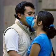 SAFE SMOOCHING: A couple wearing masks kisses at the Historic Center in Mexico City. Picture by ALFREDO ESTRELLA/ AFP/ Getty Images