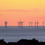 Rampion wind farm silhouetted against an orange sky. Picture by: Dave Mason, from Brighton..