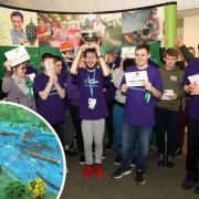 The Young Epilepsy team lifting the Jim Green Bowl, and a miniature model of a river made in the competition
