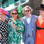 Dressed for a beautiful hot sunny day racegoers at Brighton Racecourse's Ladies Day which is part of The Star Sports Festival of Racing held in August : Credit Simon Dack / Alamy Live News