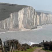 Four people were rescued after being cut off by the tide beneath the Seven Sisters cliffs