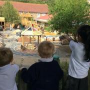 Children at the school looking at their new outdoor area