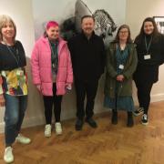 Ricky Gervais, centre, with staff at Brighton Museum and Art Gallery