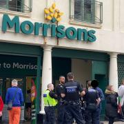 Officers were seen outside the supermarket in Kemp Town yesterday afternoon