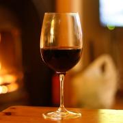 A wine glass by a fireplace
