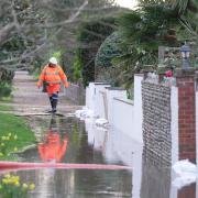 Flood teams have battled to protect homes after heavy rain struck Sussex