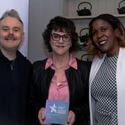Iris Jackson, OG Kicks head of operations, centre with the award and Simona Daniel and Gary Salters of the Federation of Small Businesses