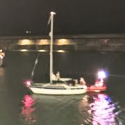 The boat being escorted back into the marina