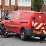 A woman suffered minor injuries following a crash involving a mobility scooter and Royal Mail van