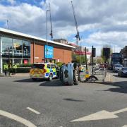 Updates after car overturns at busy junction with road closed