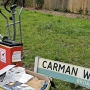 A cross trainer was among rubbish dumped by dog poo bins