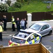 A man was arrested for dangerous driving following a crash with a police car in Brighton on Sunday afternoon