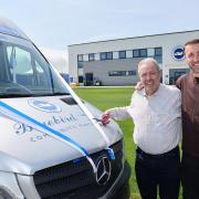 Paul Samrah, left, is honoured with a minibus at Albion's training ground with Glenn Murray