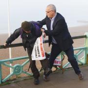 Blogger and protester scuffle on Brighton seafront as TV cameras roll