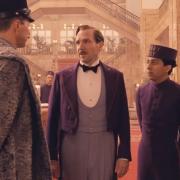 The back of Edward Norton and the fronts of Ralph Fiennes & Tony Revolori in The Grand Budapest Hotel...