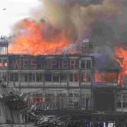 Left, the West Pier in flames after the famous GradeI listed building caught alight
