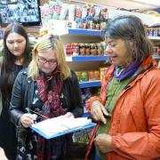 Dee Edmonds getting signatures in the Best One Express. Picture by Della Cheshire