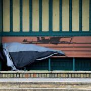 A man sleeping rough in a shelter on Hove seafront