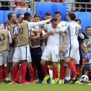 Jamie Vardy is mobbed by his team-mates after coming off the bench to equalise in England’s 2-1 win against Wales at Euro 2016 yesterday