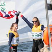 Saskia Clark and Hannah Mills celebrate on the water after winning gold
